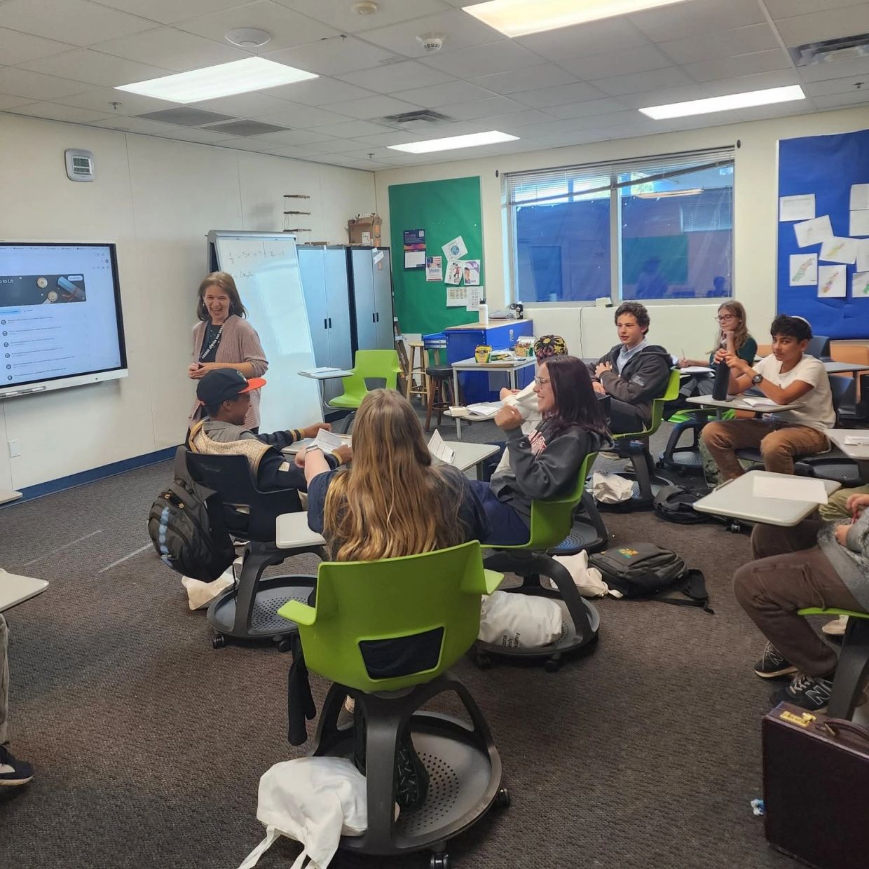 Students and teacher engaged in a classroom discussion.