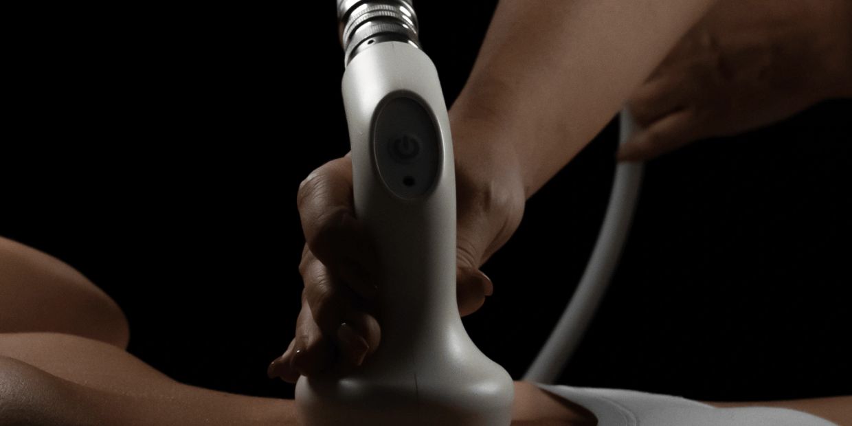 Close-up of a hand holding a massage device during treatment.