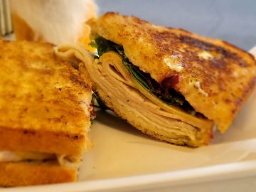 Turkey, white cheddar, cranberry, sage mayo & arugula mix on sourdough