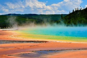 Colorful hot spring in a natural landscape.