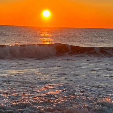 Sunset over ocean waves.