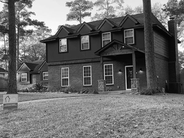 A two-story suburban house with a front lawn.