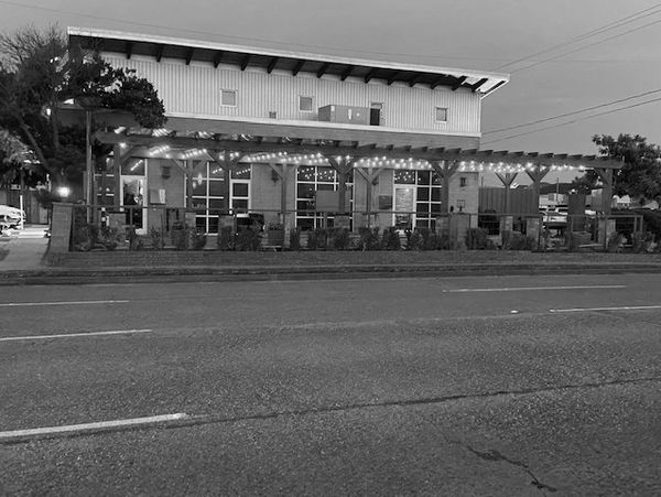 Modern building with patio lights along the street.