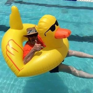 Jack Lynch in an old time bathing suit sitting in Howard the Duck huge, yellow rubber duck float.