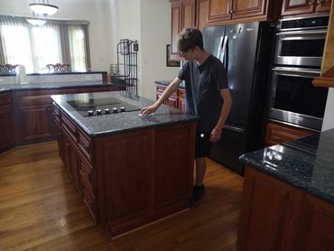 sanitize kitchen, wiping down counter, cleaning stove, cleaning oven,