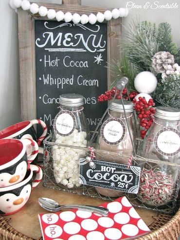 Festive hot cocoa station with penguin mugs and toppings in jars.