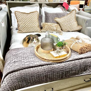 new bedding with decor elegantly displayed on top with kitty