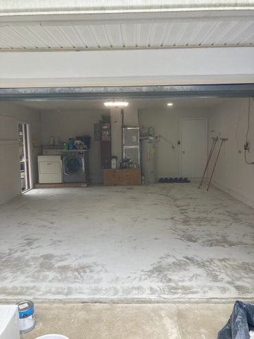 Clean garage with laundry area and utility equipment.