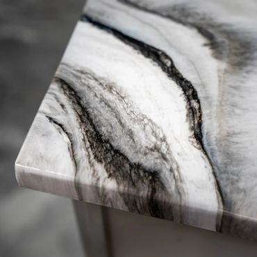 Close-up of a marble tabletop with black and white veining patterns.