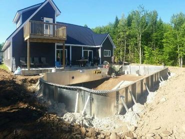 Inground swimming pool installation, steel walls assembled during dig