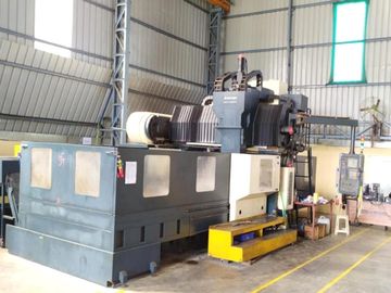 Large industrial CNC machine inside a factory workspace.