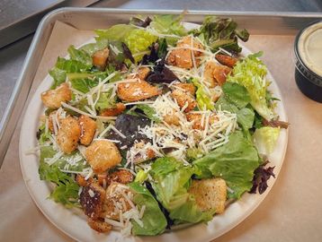 Caesar salad with lettuce shredded parmesan cheese and house made croutons