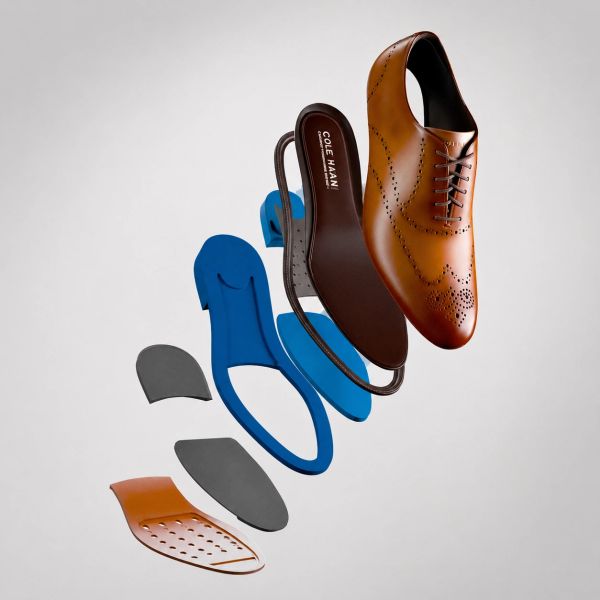 Exploded view of a brown leather dress shoe showing its multiple inner components.