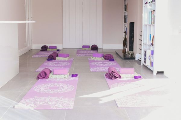 A room with yoga mats on the floor