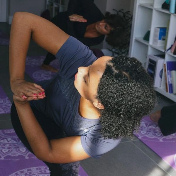 Two people practicing yoga