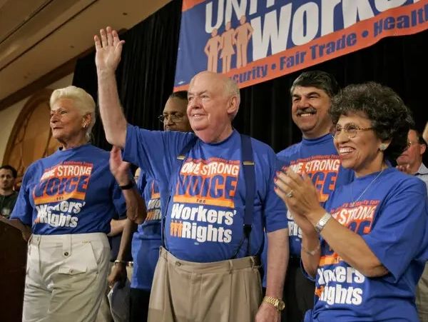 Group of workers advocating for workers' rights at a rally.