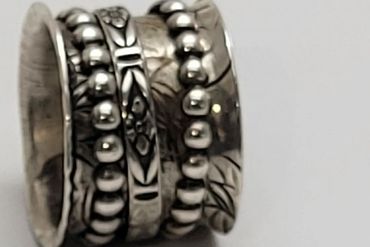 A detailed Sterling Silver ring with intricate bead and floral patterns. S60.00 USA Dollars