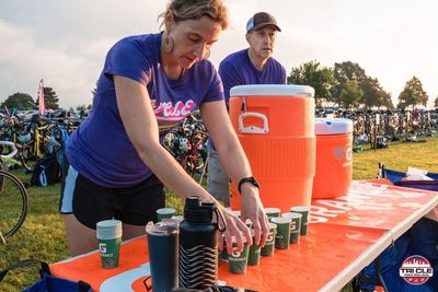 Tri CLE volunteers in transition putting cups in water