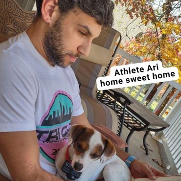 Participant Ari wearing his Tri CLE shirt with his dog on his lap #tricleshirtsinthewild