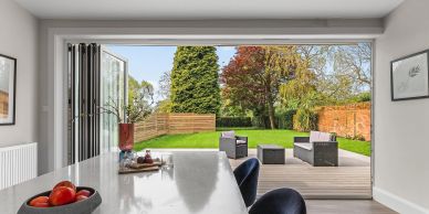 Modern dining room opening to a backyard patio.