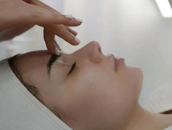 Client receiving microneedling RF facial treatment for firm and rejuvenated skin