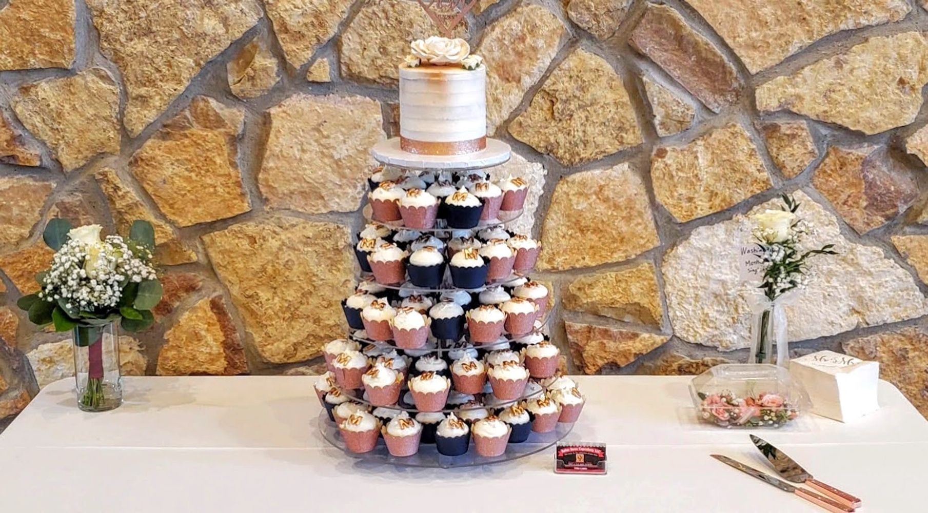 Wedding cake and cupcakes in rose gold.