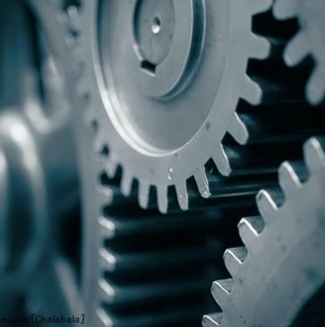 Close-up of interlocking metallic gears in motion.