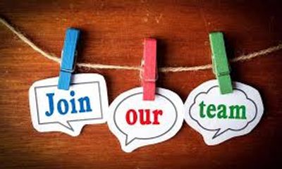 Colorful clothespins hold 'Join our team' signs on a string.