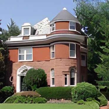 Victorian-style red brick house with a rounded turret