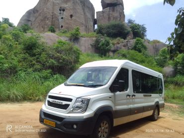White Force Urbania van parked in front of rocky terrain.
