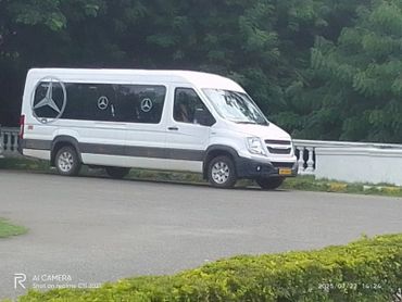 White Force Urbania van for rent in Bangalore with large Mercedes logos on windows.