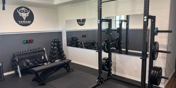 Neat home gym setup with weights and bench.