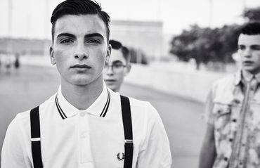 Black and white portrait of young man on street