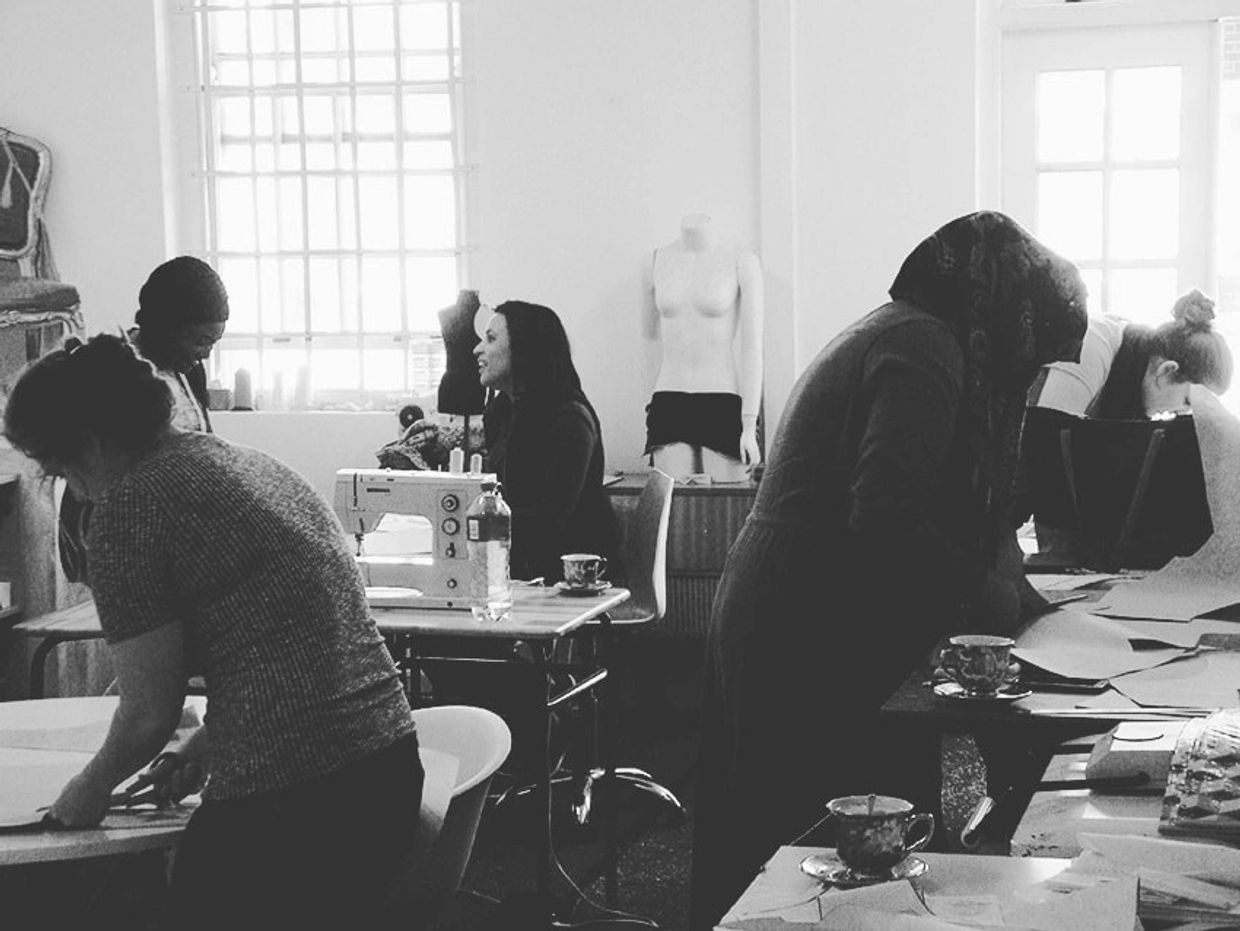 women and men at sewing class