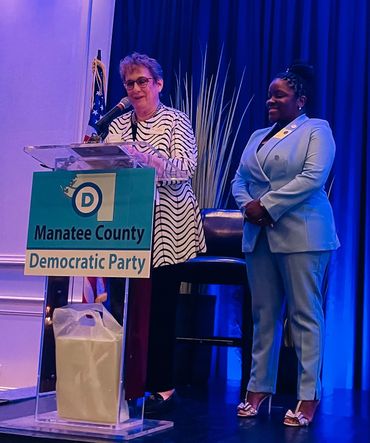 Gala chair Lucy Lapides presents an award to the MCDBC and caucus president Michelle Grimsley.