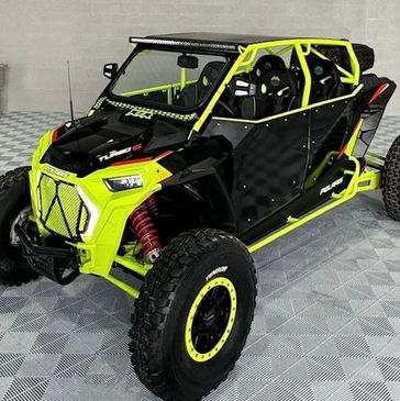 Bright yellow and black off-road buggy in showroom.