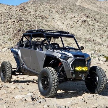 Off-road vehicle parked on rocky terrain.