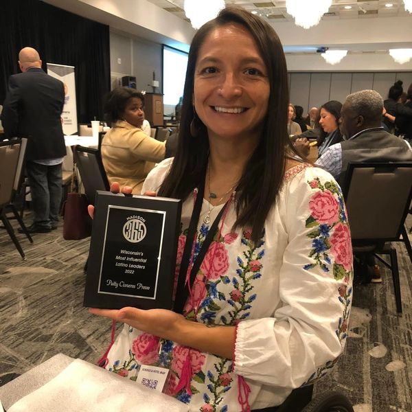 Patty smiling holding a plaque that reads "Wisconsin's Most Influential Latino Leaders 2022"