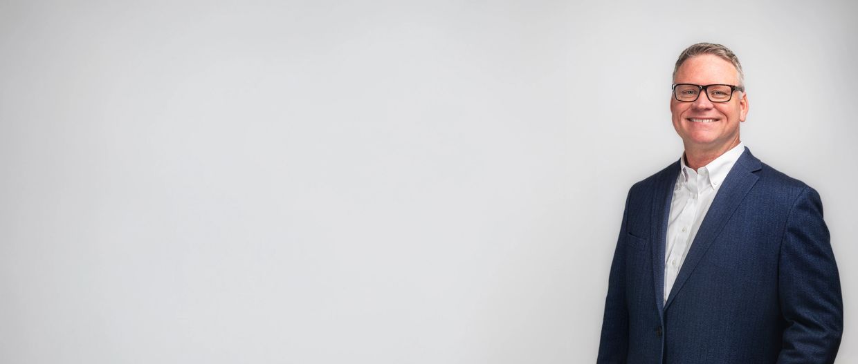 Charleston Headhsot and Branding photographer makes a studio portrati of a man wearing glasses