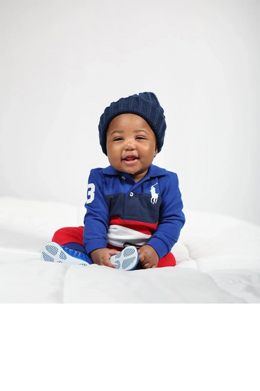 Fine Art Baby Portrait Editorial Vibe Charleston SC. White backdrop boy on white bed big smiles