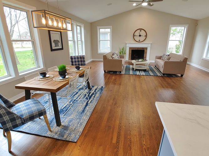 Refinished hardwood flooring painted walls with trim work installation.