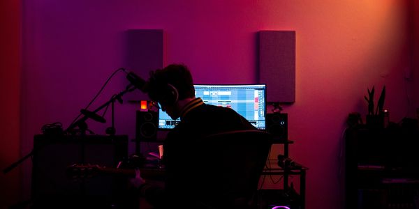 Me playing guitar at my desktop in my home studio.