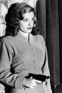 A brunette 1940s bombshell with a gun