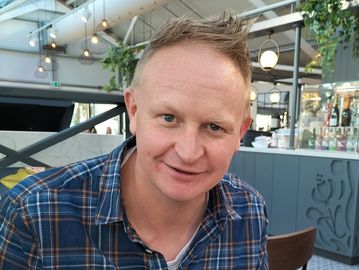 Man smiling in a casual setting.