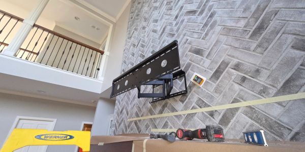 TV wall mount installation setup in a modern room.