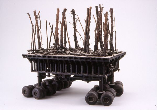 a miniature dying forest on wheels
