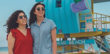 a couple having their pictures taken by a professional photographer