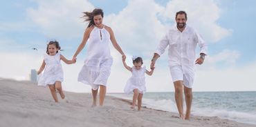 A family enjoying a photo shoot at the beach