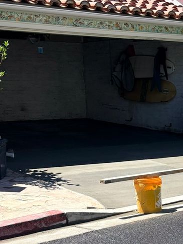 Concrete driveway leading to a residential garage completed by Archon Concrete Construction.