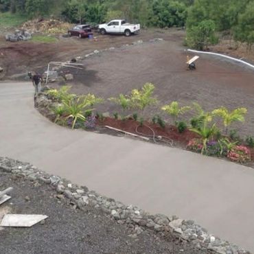 Custom curved concrete walkway installation on the Big Island of Hawaii featuring a smooth finish, l